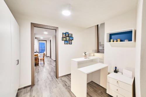 a white bathroom with a sink and a table at Case Vacanze da Birba in Ravello