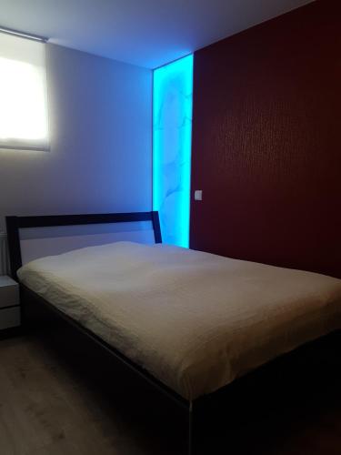 a bedroom with a bed with a blue light at Business Apartment Lippstadt Nord 50 qm in Lippstadt