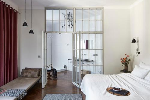 a bedroom with a bed and a table and a chair at Between Us Bed and Breakfast in Warsaw