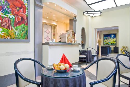 a dining room with a bowl of fruit on a table at Hotel Byron in Montecatini Terme