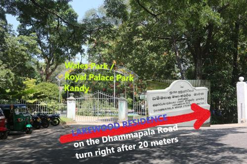 a sign in front of a park with a red arrow at Lakewood Residence in Kandy