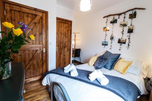 a bedroom with a bed and a wooden door at The Boathouse in Stonehaven