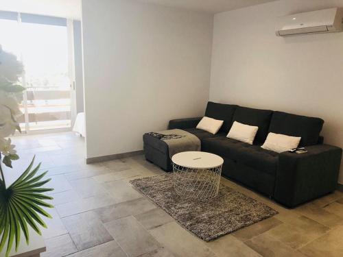 a living room with a couch and a table at Orange Studio in Vilamoura