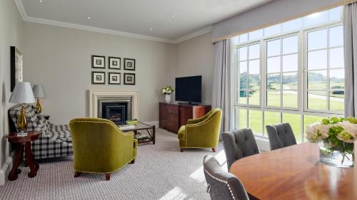 a living room with a table and chairs at Fairmont St Andrews, Scotland in St. Andrews