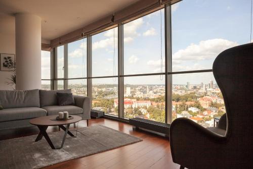 a living room with a couch and a table at Luxury Panoramic Vilnius apartment in Vilnius