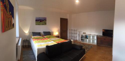 a living room with a bed and a couch at Mariazeller Rooms in Mariazell