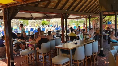 a group of people sitting at tables in a restaurant at Sidari Waterpark in Sidari