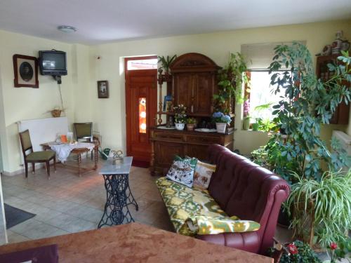 a living room with a couch and a table at Edelweiss Panzió in Pilisvörösvár
