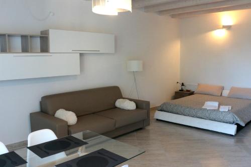 a living room with a couch and a bed at Paradeisos Residence Sas in Somma Lombardo