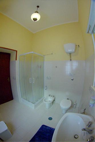 a bathroom with a shower and a toilet and a sink at La Collina di nonno Carmine in Santa Paolina