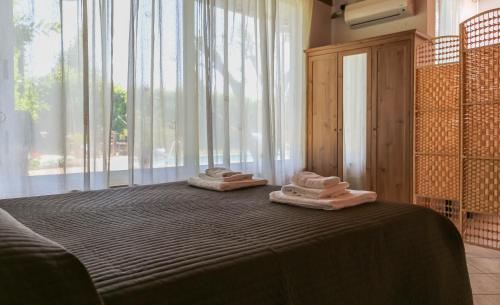a bedroom with a bed with two towels on it at Casa Lupita in Terracina