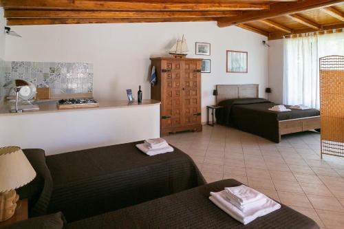 a hotel room with two beds and a kitchen at Casa Lupita - Private Family Villa with Pool & Garden in Terracina