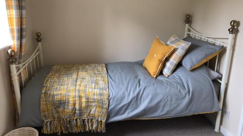 a bed with pillows on it in a bedroom at 1 Silkin Serviced Accommodation in Newton Aycliffe