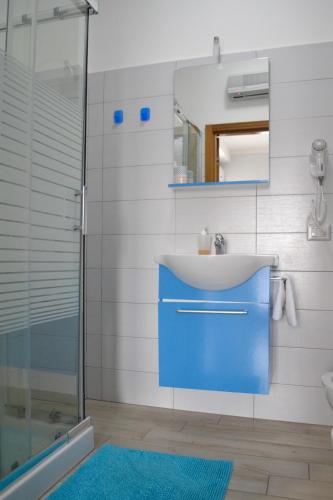 a bathroom with a blue sink and a shower at Pompei Gryllus in Pompei