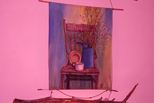 a painting of a chair with a cup and a vase at Suikerbosrant Sleep and go in Pretoria