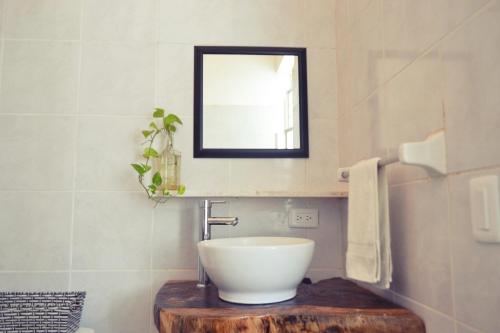 a bathroom with a bowl sink and a mirror at Casa Pancho Playa in San Francisco