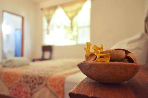a bowl of food sitting on a table next to a bed at Casa Pancho Playa in San Francisco