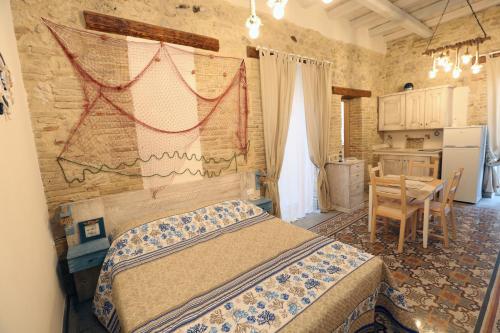 a bedroom with a bed and a table in it at ANTICA DIMORA DELL'AMMIRAGLIO in Licata