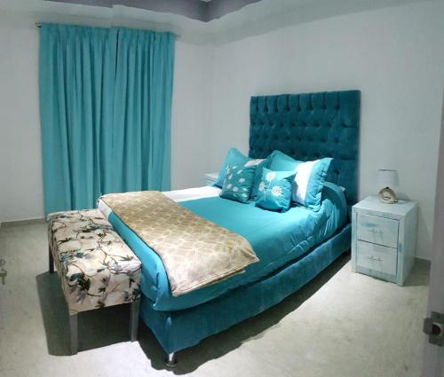 a bedroom with a blue bed with blue pillows at Departamento Privado 3 recamaras in Mexico City