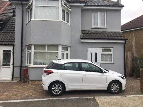 a white car parked in front of a house at Hameway House in London