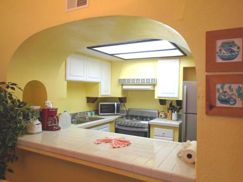 a kitchen with an archway in the middle of it at La Paloma Beach&Tennis Resort in Rosarito