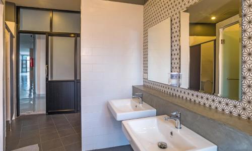 a bathroom with two sinks and a mirror at Srisuksant Square in Krabi town