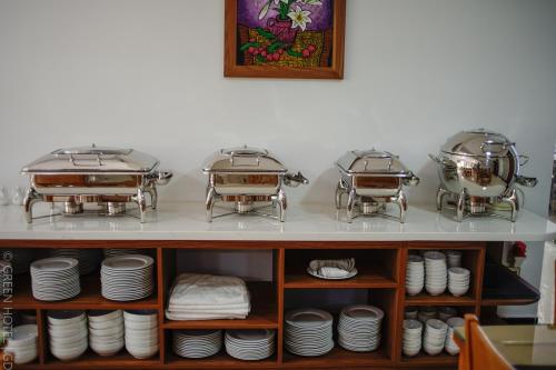 two pots and pans on a shelf with plates at Green Hadong Hotel in Hà Ðông