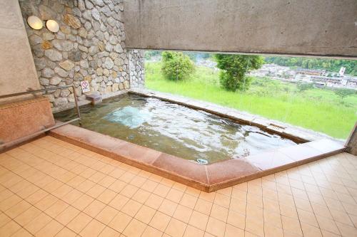 a large pool of water in a room with a window at Hotel Seira Shimanto in Shimanto