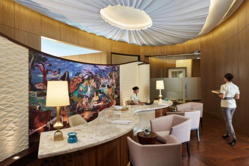 a rendering of a hotel lobby with a painting on the wall at Raffles Jakarta in Jakarta