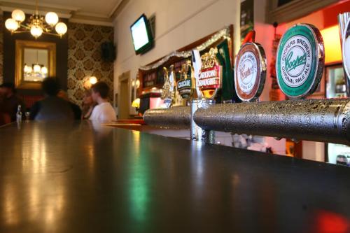 a bar with a row of beers on the counter at Hotel Metropolitan in Adelaide