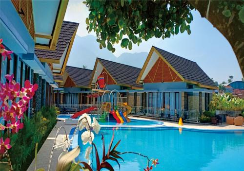 a pool at a resort with a playground at Cahaya Villa Garut in Garut