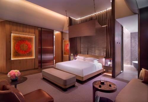 a bedroom with a bed and a living room at Grand Hyatt Xi'an in Xi'an