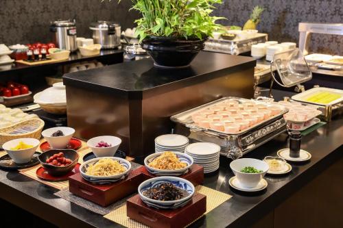 a buffet line with different types of food on a table at Osaka Garden Palace in Osaka