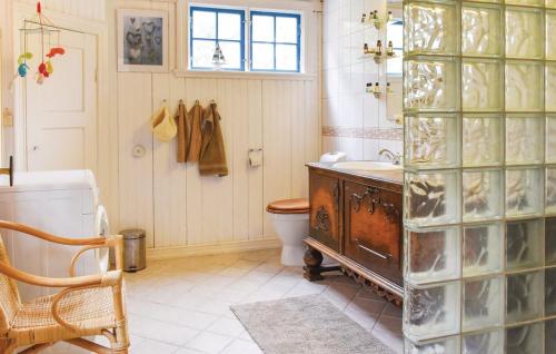 a bathroom with a tub and a toilet and a sink at Ljunghusen in Höllviken