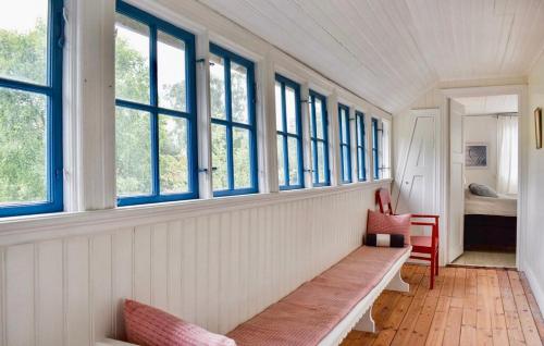 a room with a bench in a room with windows at Ljunghusen in Höllviken