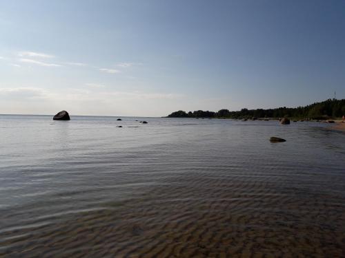 a view of a beach with rocks in the water at Klaukse in Kolga-Aabla