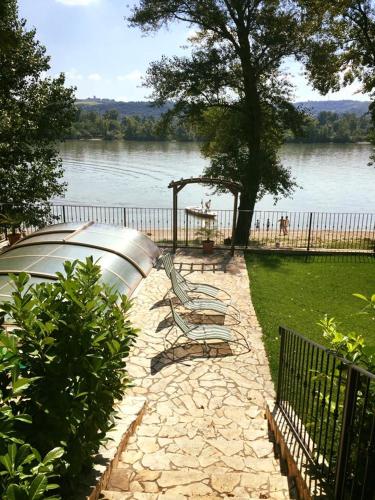 a boat sitting in a yard next to a lake at Mlyn Penzion & Wellness in Radvaň nad Dunajom
