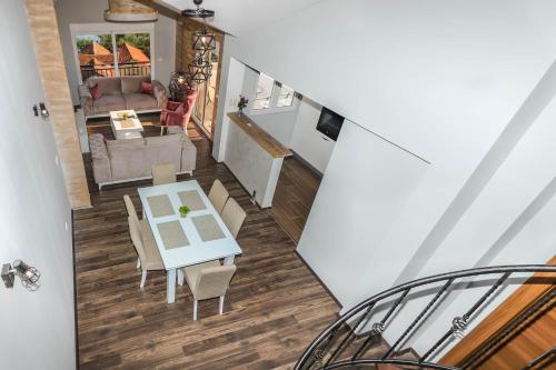 a dining room and living room with a table and chairs at JR Luxury Apartment in Kotor