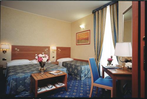 Кровать или кровати в номере Hotel Dieci