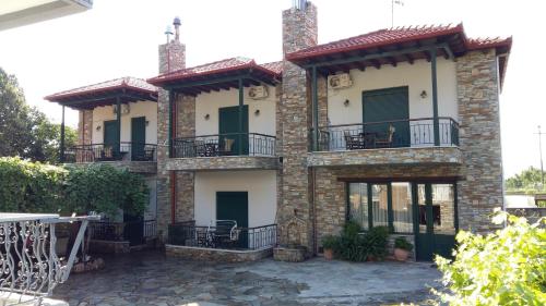 a house with balconies on the side of it at Guesthouse Oneiro in Kato Loutraki