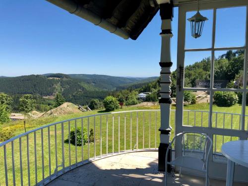 a view from the porch of a house with a view at Haus Schneekappe (Winterberg) in Winterberg