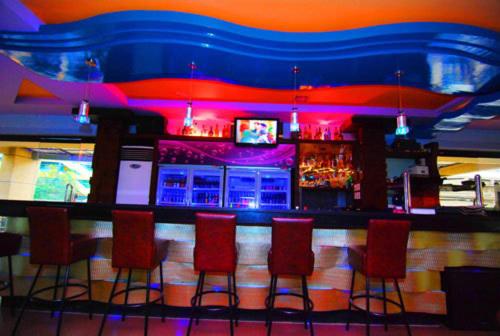 a bar with red chairs and a blue bar at MO2 Westown Hotel - Mandalagan in Bacolod