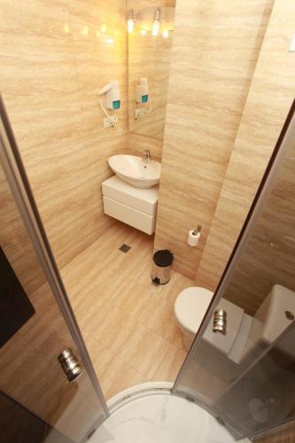 a small bathroom with a sink and a toilet at West Plaza Hotel in Bucharest
