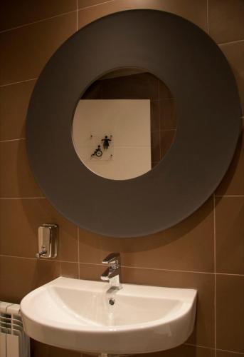 a bathroom with a mirror above a sink at Apartamentos Rurales Las Vegas de Cardeo in Las Vegas De Cardeo