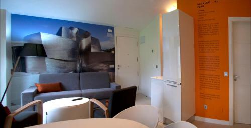 a living room with a couch and a table and chairs at Apartamentos Rurales Las Vegas de Cardeo in Las Vegas De Cardeo