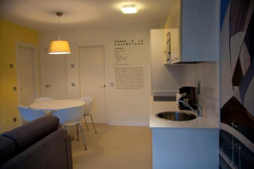 a small kitchen with a sink and a table at Apartamentos Rurales Las Vegas de Cardeo in Las Vegas De Cardeo