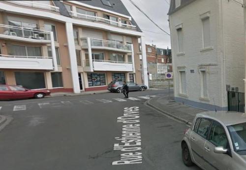 a person is standing in the middle of a street at Appartement "l'Univers Marin" - 50m Front de Mer in Berck-sur-Mer