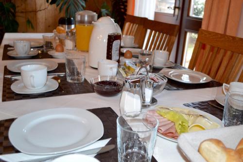 a table with plates of food on it at Gästehaus Pfisterer in Bad Schallerbach