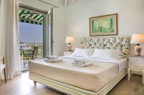 a bedroom with a bed with two towels on it at Afrodite Luxury Villa in Svoronata