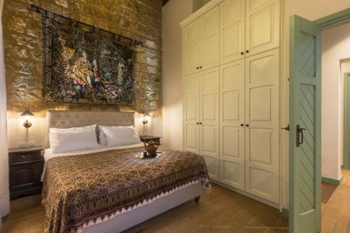 a bedroom with a bed and a painting on the wall at Tafros Villa in Rhodes Town